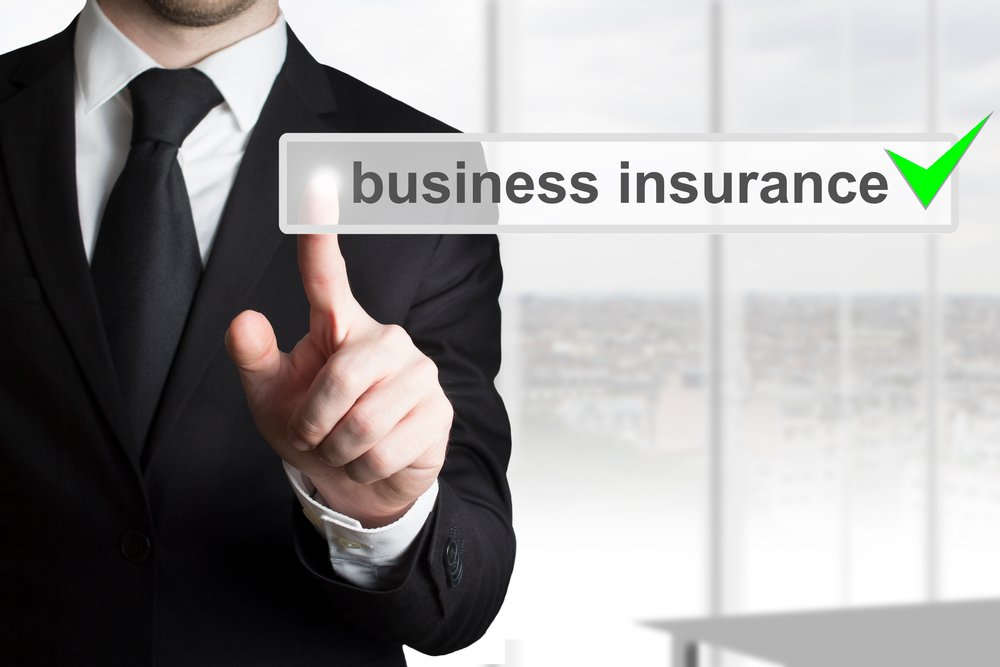 An image showcasing a professional insurance agent discussing business insurance options with a small business owner in Lancaster, Ohio, emphasizing the comprehensive coverage plans offered by Insurance Company Lancaster Ohio LLC.