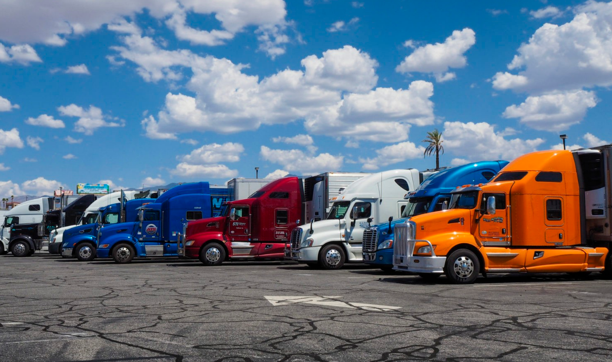 a large commercial truck on an open road with clear skies, representing comprehensive trucking insurance coverage provided by Insurance Company Lancaster Ohio.