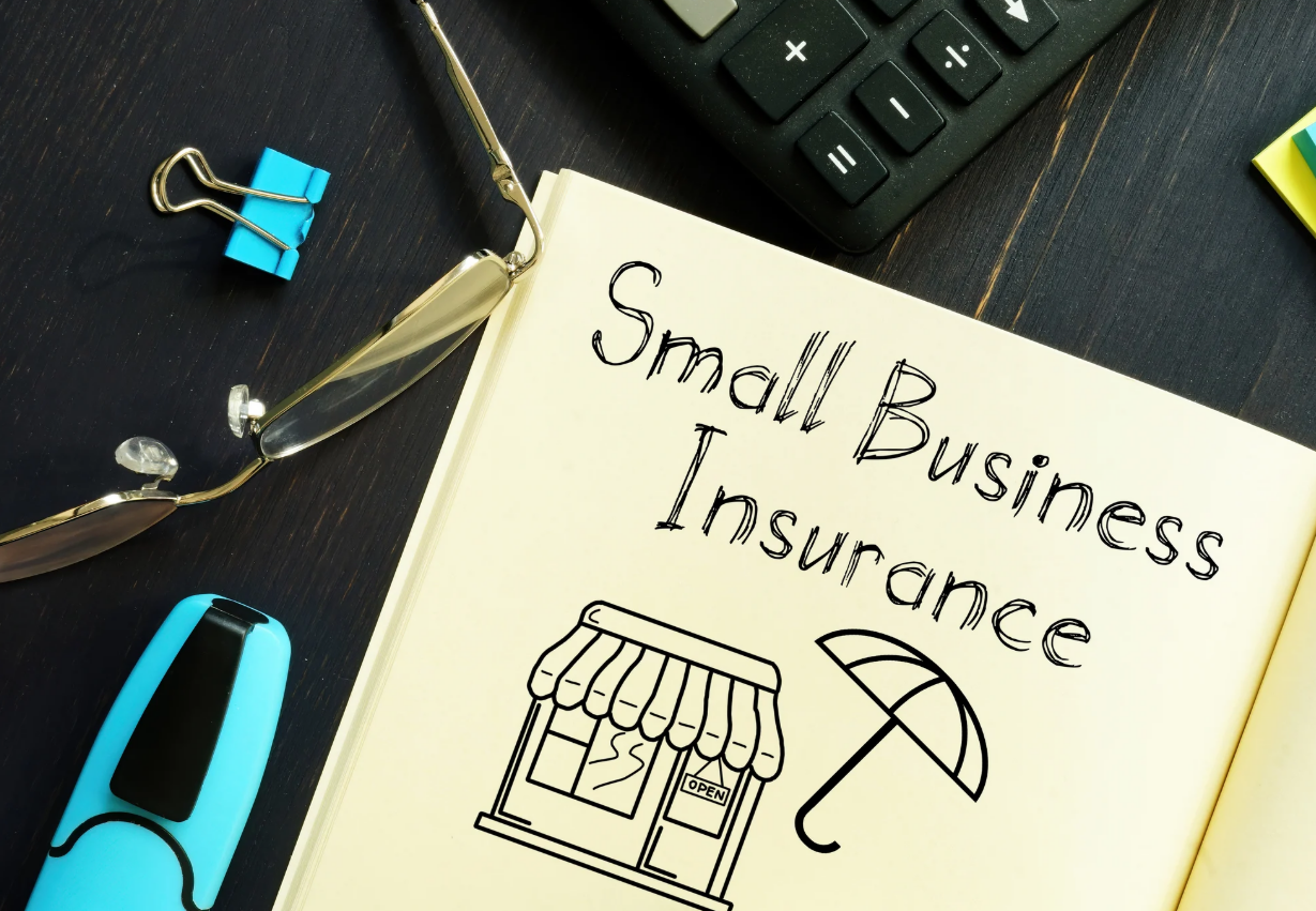 a professional business owner standing confidently in front of their small business, symbolizing comprehensive small business insurance coverage offered by Insurance Company Lancaster Ohio LLC. The background includes the Lancaster Ohio skyline, representing the local expertise and personalized insurance solutions tailored for businesses in the area.